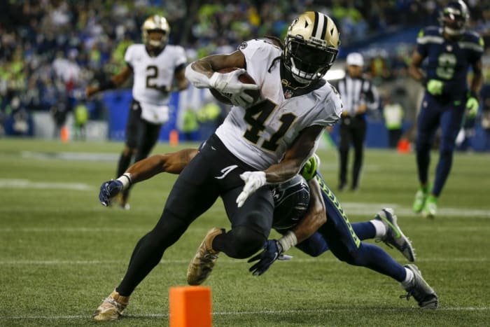 New Orleans Saints running back Alvin Kamara (41) breaks a tackle by Seattle Seahawks defensive back Ryan Neal (26) to score a touchdown. Mandatory Credit: Joe Nicholson-USA TODAY Sports